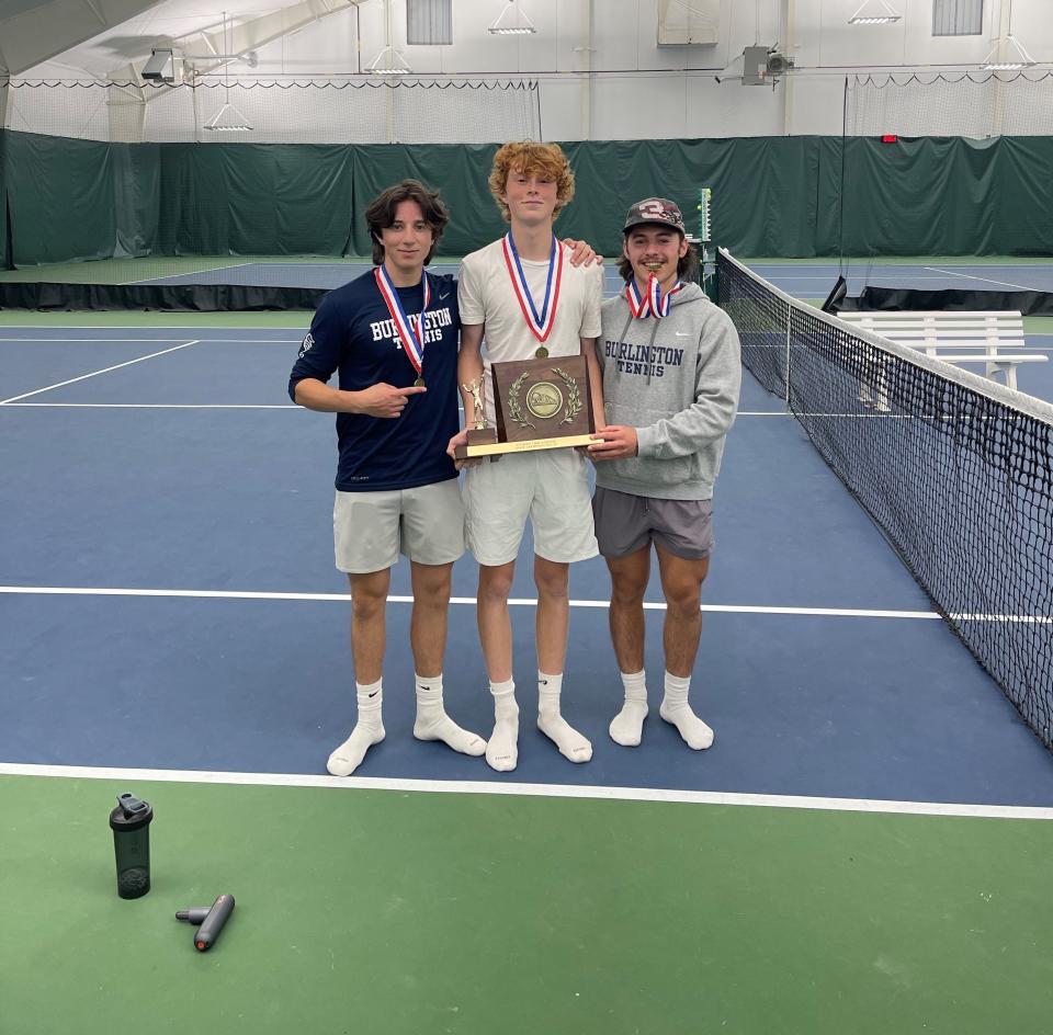 Isaac Dunkiel, left, Nevin Morton, center, and Daniel Wick pose after Burlington claimed the 2023 boys tennis state championship.