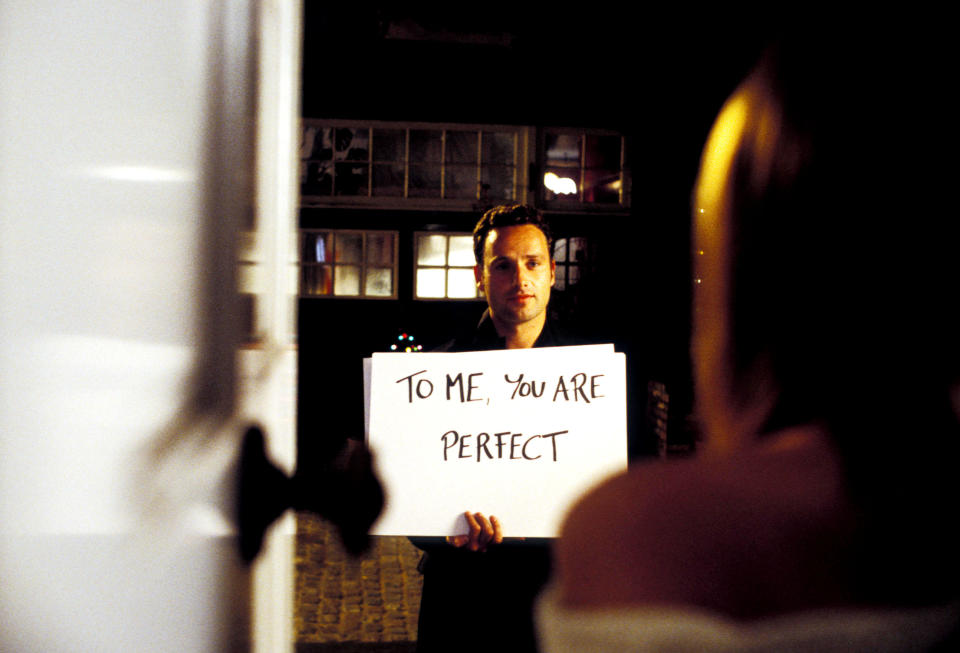 Andrew Lincoln holding a sign that says "To me, you are perfect" in Love, Actually