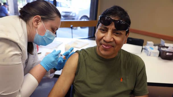 PHOTO: Gustavo Perez gets an  influenza vaccine from pharmacist Patricia Pernal during an event hosted by the Chicago Department of Public Health at the Southwest Senior Center, Sept. 9, 2022, in Chicago. (Scott Olson/Getty Images)