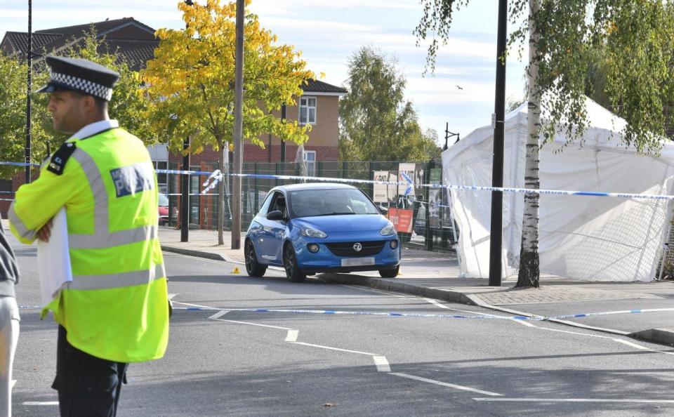 Police at the scene where the two men were stabbed at 10.30pm on Friday night (PA)