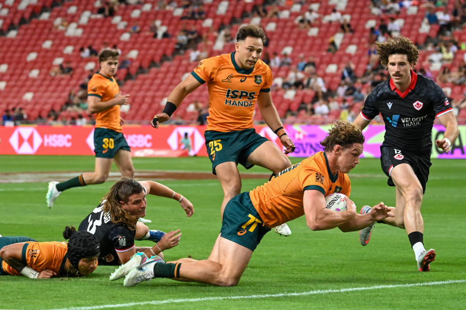 Australia's Michael Hooper scores a try during the men's group match between Australia and Canada of the HSBC Rugby Sevens Singapore tournament at the National Stadium in Singapore on May 3, 2024. (Photo by Roslan RAHMAN / AFP) (Photo by ROSLAN RAHMAN/AFP via Getty Images)