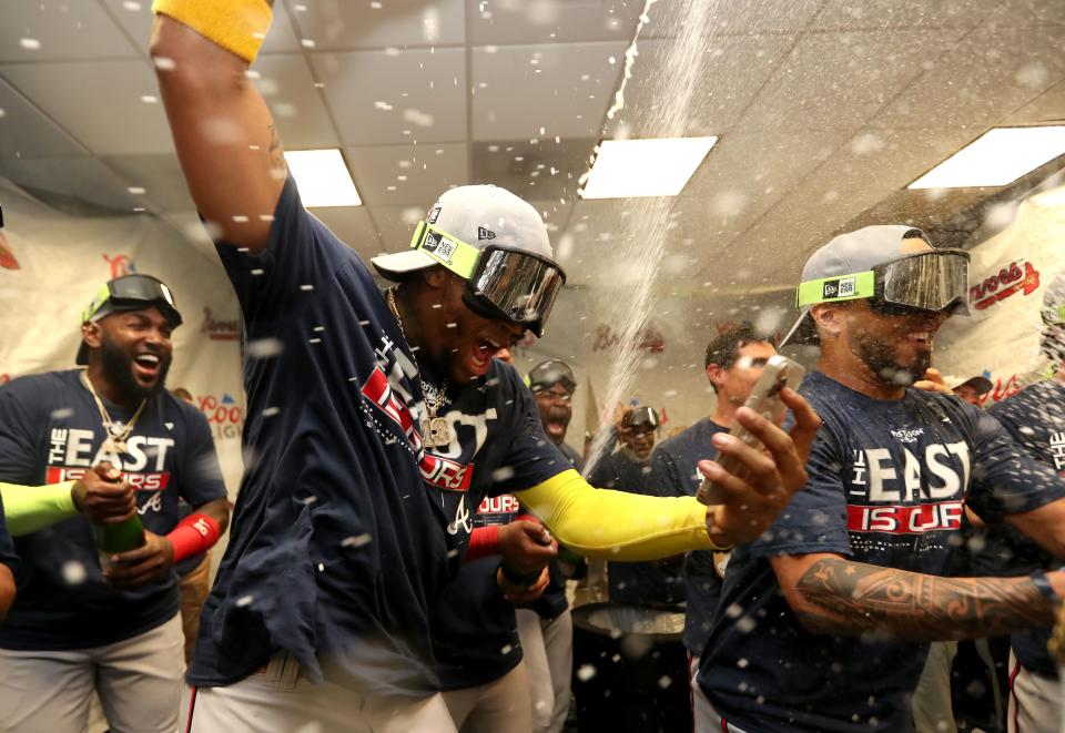 MIAMI, FLORIDA - OCTOBER 04: Ronald Acuna Jr. #13 of the Atlanta Braves celebrates after clinching the division against the Miami Marlins at loanDepot park on October 04, 2022 in Miami, Florida. (Photo by Megan Briggs/Getty Images)