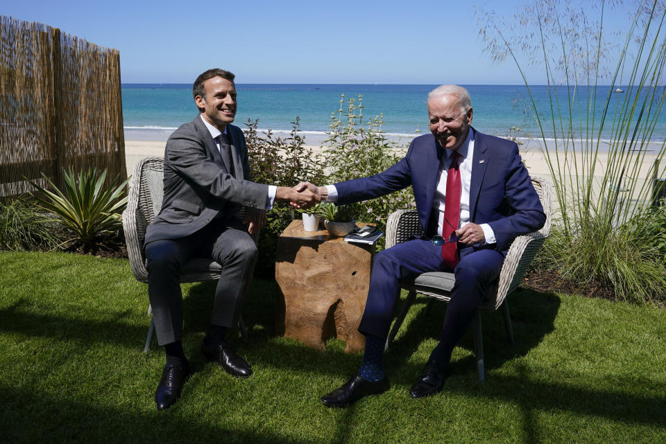 President Joe Biden and French President Emmanuel Macron shake hands as they visit during a bilateral meeting at the G-7 summit, Saturday, June 12, 2021, in Carbis Bay, England. (AP Photo/Patrick Semansky)