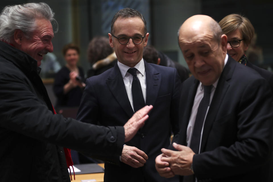 Germany's Foreign Minister Heiko Maas, center, talks to France's Foreign Minister Jean-Yves Le Drian, right, and Luxembourg's Foreign Minister Jean Asselborn during an European Foreign Affairs Ministers meeting at the European Council headquarters in Brussels, Monday, Jan. 21, 2019. (AP Photo/Francisco Seco)