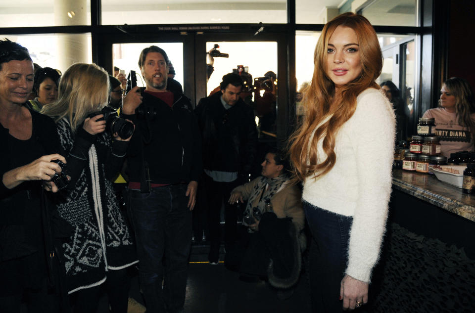 Actress Lindsay Lohan poses as she is surrounded by media following a news conference at the 2014 Sundance Film Festival, Monday, Jan. 20, 2014, in Park City, Utah. Producer Randall Emmett and Lohan announced the forthcoming production of a new film, "Inconceivable," in which Lohan will star and co-produce. (Photo by Chris Pizzello/Invision/AP)