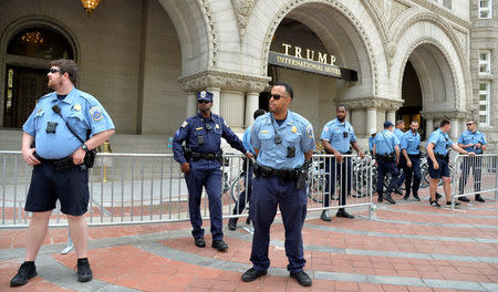 Poilce and security personnel are deployed in front of the Trump International Hotel as demonstrators march down Pennsylvania Avenue during a People's Climate March, to protest U.S. President Donald Trump's stance on the environment, in Washington, U.S., April 29, 2017. REUTERS/Mike Theiler