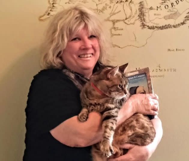 The author's mother in the J.R.R. Tolkien Room at Sylvia Beach Hotel in Nye Beach, Oregon, with the resident cat in 2014. (Photo: Courtesy of Melissa Hart)