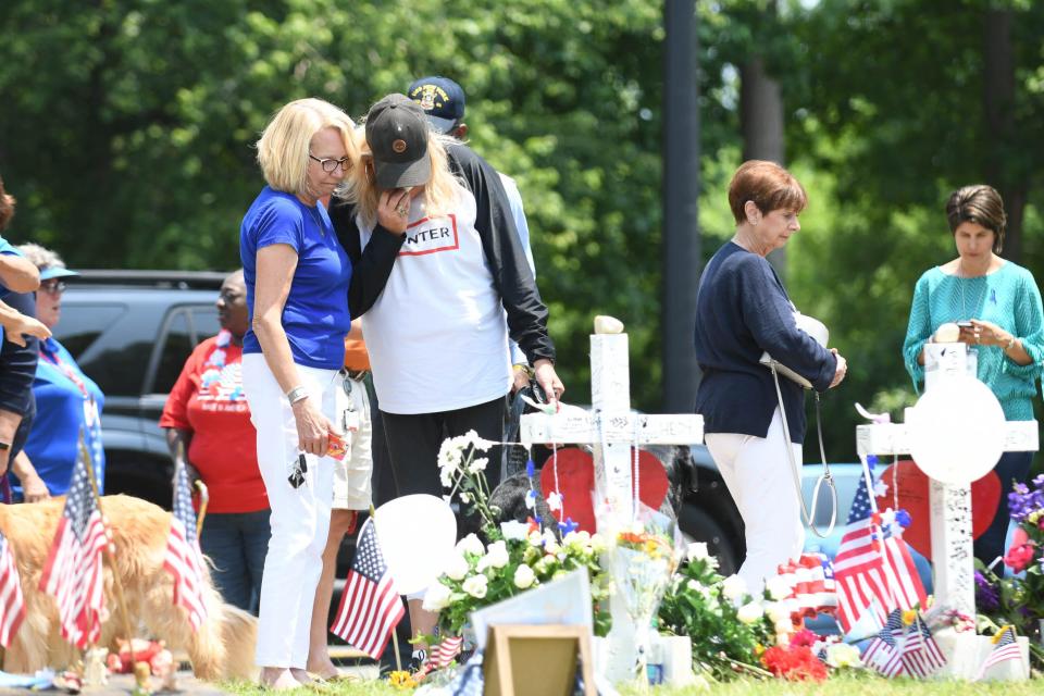 People stop by the memorial at the Municipal Center to pay their respects on June 3, 2019, for the victims of the mass in Virginia Beach, Va.