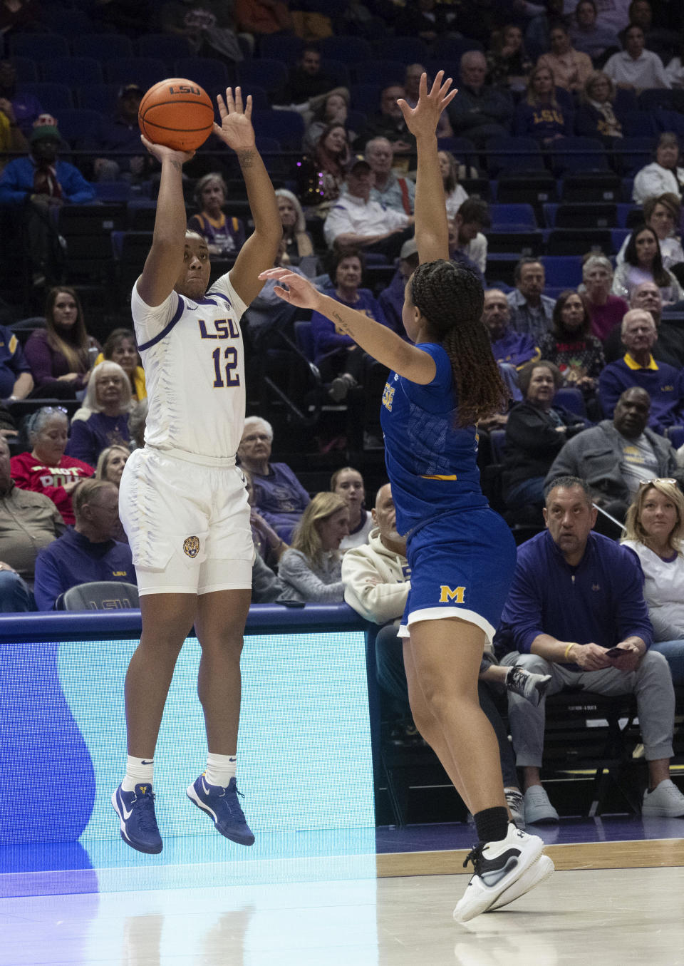 LSU guard Mikaylah Williams (12) takes a shot over McNeese guard Azjah Reeves during an NCAA basketball game, Tuesday, Dec. 12, 2023, in Baton Rouge, La. (Hilary Scheinuk/The Advocate via AP)