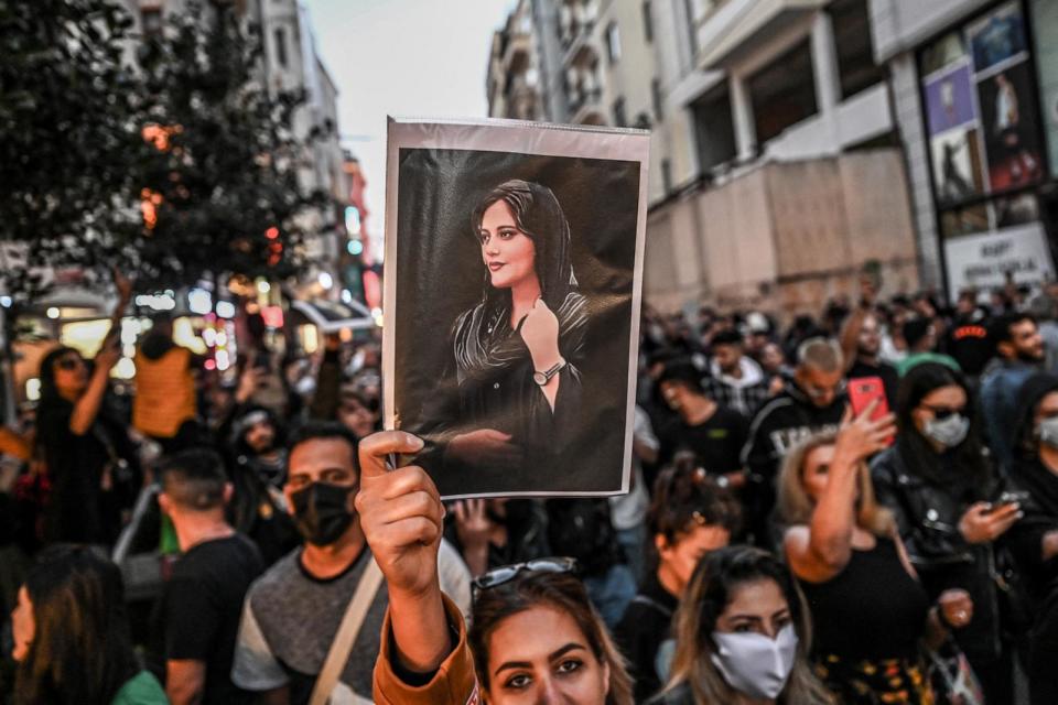 PHOTO: A protester holds a portrait of Mahsa Amini  during a demonstration in support of Amini, a young Iranian woman who died after being arrested in Tehran by the Islamic Republic's morality police, on Istiklal avenue in Istanbul on September 20, 2022. (Ozan Kose/AFP via Getty Images)