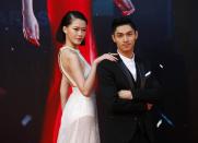 Hong Kong actor Kelvin Kwan poses with Malaysian actress Fish Liew, who is nominated for Best New Performer for her role in "Doomsday Party", on the red carpet during the 33rd Hong Kong Film Awards in Hong Kong April 13, 2014. REUTERS/Tyrone Siu (CHINA - Tags: ENTERTAINMENT)