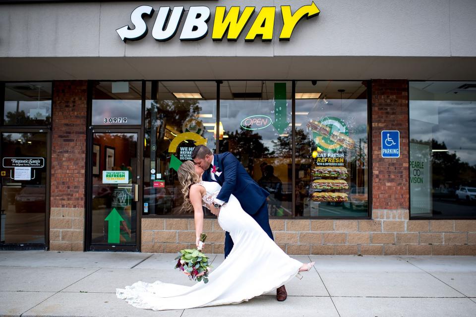 Julie Bushart &amp; Zack Williams pose outside of Subway Restaurant