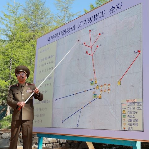A North Korean soldier explains the demolition process of the Punggye-ri nuclear test facility - Credit: Getty