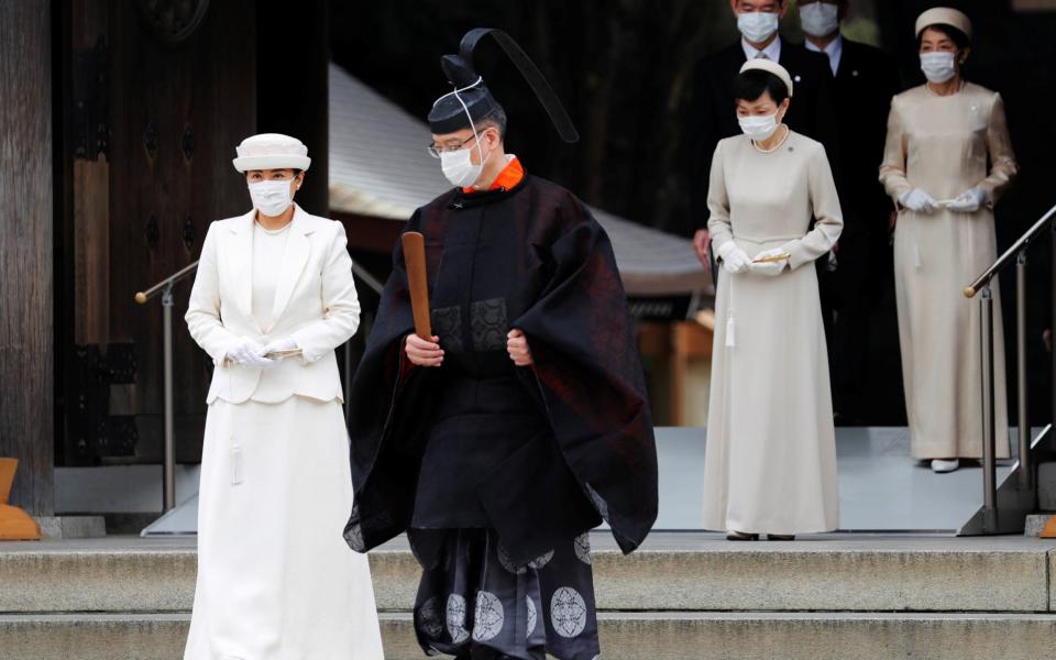 Japan's Empress Masako wears a face mask as she attends a ceremony during a celebration marking 100 years since the enshrinement of Emperor Meiji at Meiji Shrine in Tokyo - Reuters