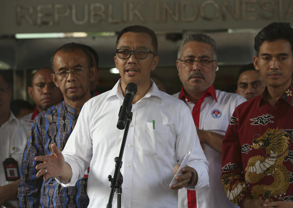 Indonesian Youth and Sports Minister Imam Nahrawi, center, gestures as he speaks to the media during a press conference in Jakarta, Indonesia, Thursday, Sept. 19, 2019. Nahrawi has stepped down from his position after being named a bribery suspect by the country's anti-graft commission. (AP Photo/Tatan Syuflana)