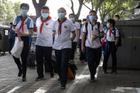 Students wearing masks to curb the spread the new coronavirus leave after the end of a school day in Beijing on Wednesday, June 3, 2020. Students in the Chinese capital have been slowly returning to school as authorities continue to restore normalcy after the shutdown over the coronavirus outbreak. (AP Photo/Ng Han Guan)