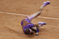 Spain's Rafael Nadal falls on the court as he attempts to return the ball to Germany's Alexander Zverev during their quarter-final match at the Italian Open tennis tournament, in Rome, Friday, May 14, 2021. (AP Photo/Gregorio Borgia)