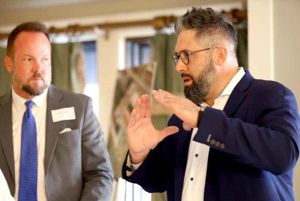 Tony Capucille, founder of Brightwell, talks with Norman Public Schools' Justin Milner on March 7 before a panel discussion about a solar project with the district.