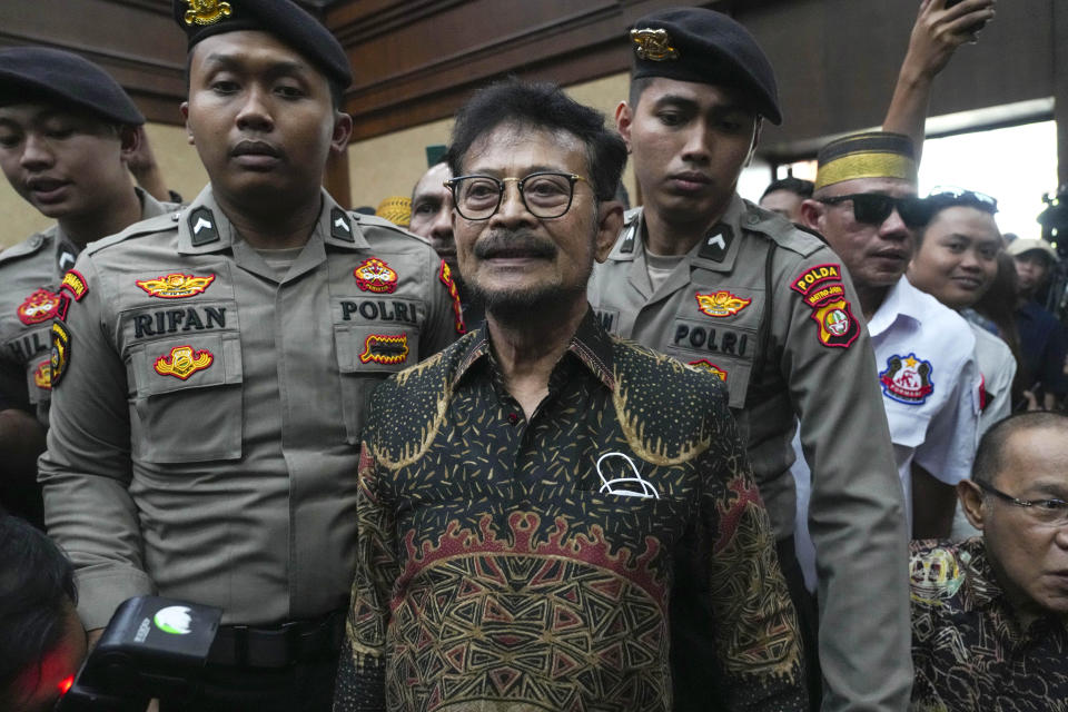Former Indonesian Agriculture Minister Syahrul Yasin Limpo, center, is escorted by police officers upon arrival for his sentencing hearing on a corruption case at the Corruption Court in Jakarta, Indonesia Thursday, July 11, 2024. Indonesia’s anti-graft court sentenced the former agriculture minister to 10 years in prison Thursday after finding him guilty of corruption-related extortion, abuse of power and bribery involving ministry contracts with private vendors. (AP Photo/Tatan Syuflana)