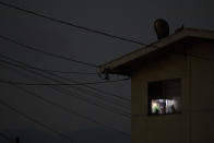 In this Thursday, Sept. 6, 2018, photo, electrical wires run into an apartment building as a room is lit by a TV screen in Salinas, Calif. Nearly a quarter of the state's resident's live in poverty, the highest rate in the country, according to the U.S. Census Bureau. Median annual earnings in the state rose by a fraction of the increase in housing costs from 2006 to 2016, according to the California Budget and Policy Center. (AP Photo/Jae C. Hong)