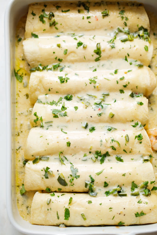 <p>Little Spice Jar</p><p>Shrimp and veggie-loaded enchiladas topped with a simple homemade creamy poblano sauce and freshly grated cheese.</p><p><strong>Get the recipe: <a href="https://littlespicejar.com/shrimp-enchiladas-creamy-poblano-sauce/" rel="nofollow noopener" target="_blank" data-ylk="slk:Shrimp Enchiladas with Creamy Poblano Sauce;elm:context_link;itc:0;sec:content-canvas" class="link ">Shrimp Enchiladas with Creamy Poblano Sauce</a></strong></p>