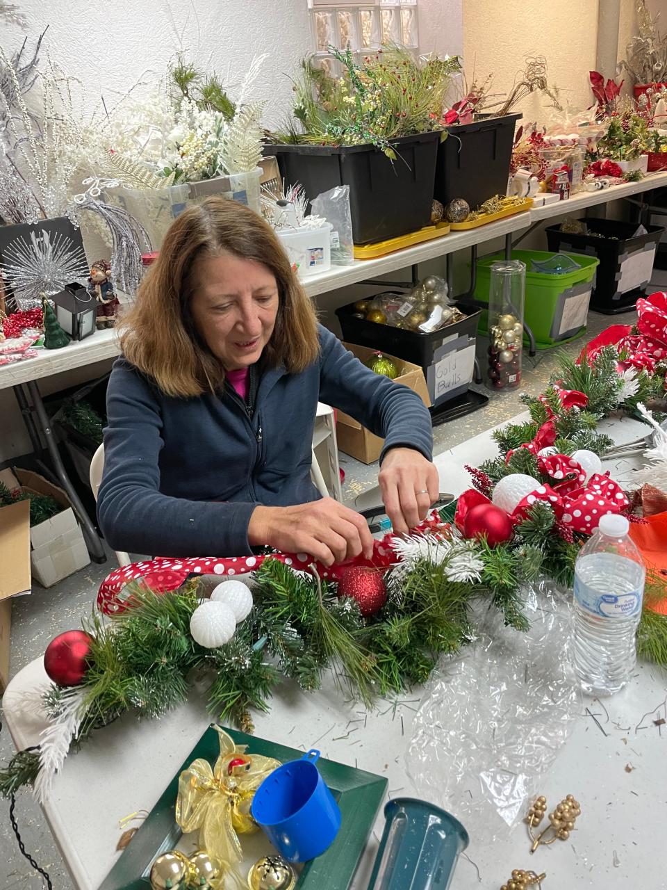 Christy Klug of Moon, a member of the Moon Township Garden Club, crafts a Christmas garland for the Holiday Greens & Gift Shoppe on Dec. 3.