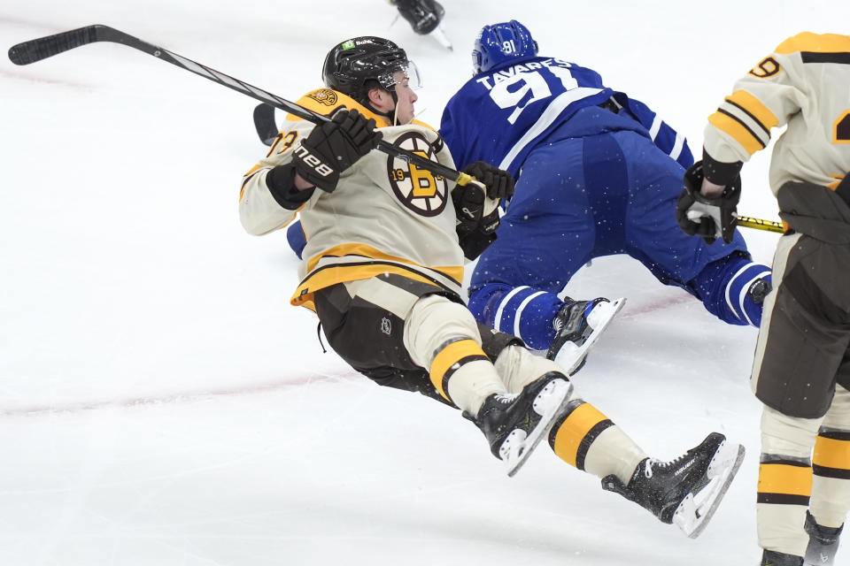 Boston Bruins defenseman Charlie McAvoy (73) and Toronto Maple Leafs center John Tavares (91) hit the ice after colliding in the first period of an NHL hockey game, Thursday, March 7, 2024, in Boston. (AP Photo/Steven Senne)