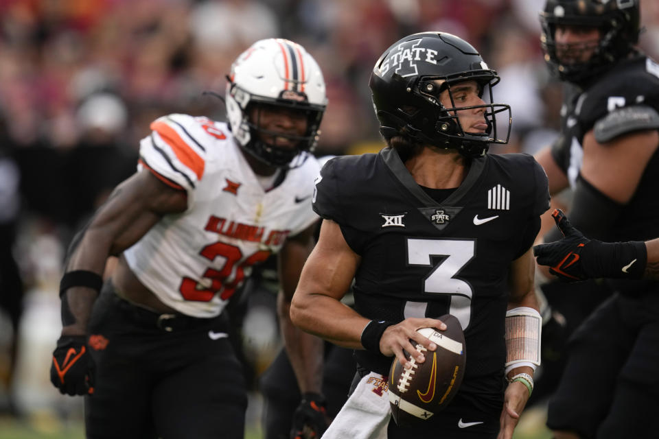 Iowa State quarterback Rocco Becht (3) looks to pass as he is pressured by Oklahoma State linebacker Collin Oliver (30) during the first half of an NCAA college football game, Saturday, Sept. 23, 2023, in Ames, Iowa. (AP Photo/Charlie Neibergall)