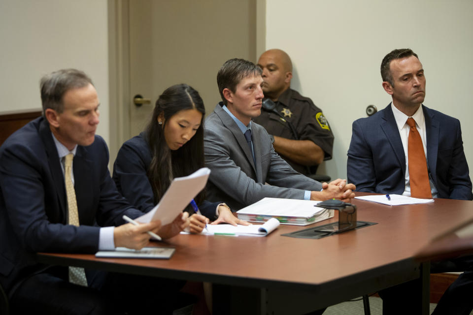 FILE - Former Grand Rapids police officer Christopher Schurr, center, listens as Judge Nicholas Ayoub binds the case for trial at the Kent County Courthouse, Oct. 31, 2022, in Grand Rapids, Mich. Lawyers for the former Michigan police officer are asking the state appeals court to throw out a murder charge in the killing of a Black motorist in 2022. The court is scheduled to hear arguments Wednesday, Sept. 6, 2023, in the case against Schurr, who shot Patrick Lyoya in the back of the head after a morning traffic stop in Grand Rapids turned into a short foot chase and vigorous struggle. (Cory Morse/MLive.com/The Grand Rapids Press via AP, Pool, File)