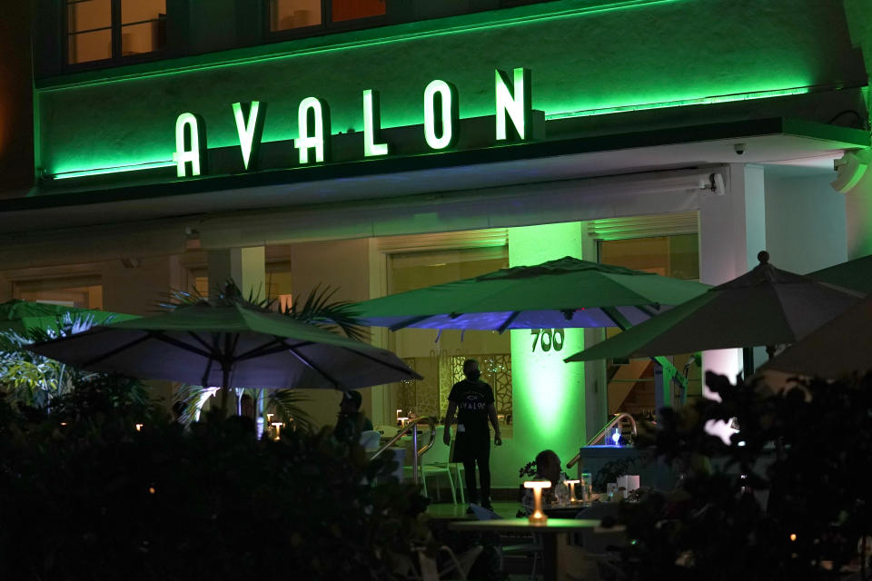 People dine outdoors at the Avalon Hotel along Ocean Drive, Friday, Sept. 24, 2021, in Miami Beach, Fla. The Avalon Hotel and its popular seafood restaurant downstairs is one of the iconic Art Deco hotels on South Beach from the 1940s. (AP Photo/Lynne Sladky)
