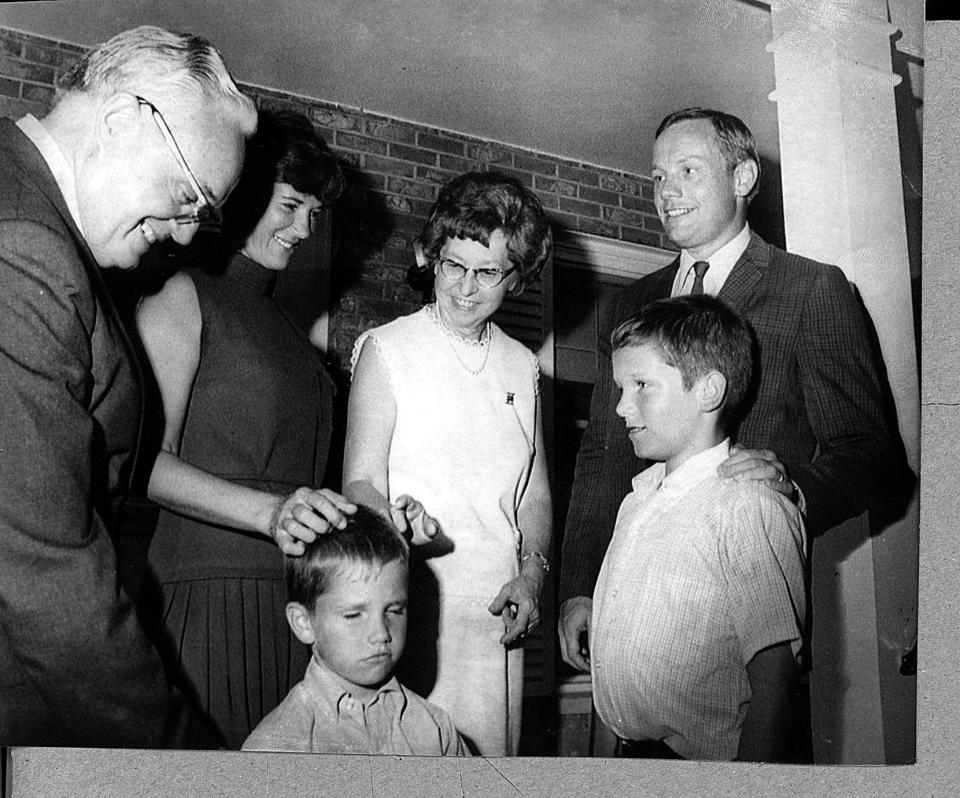 Astronaut Neil Armstrong, right, is shown with his family  after arriving at his parents' home in Wapakoneta, Ohio, on his first trip home following his historic walk on the moon.  With him are, left to right, Stephen Armstrong, father, Neil's wife, Janet, his mother, and two children, Mark, left, 6, and Eric, 12.