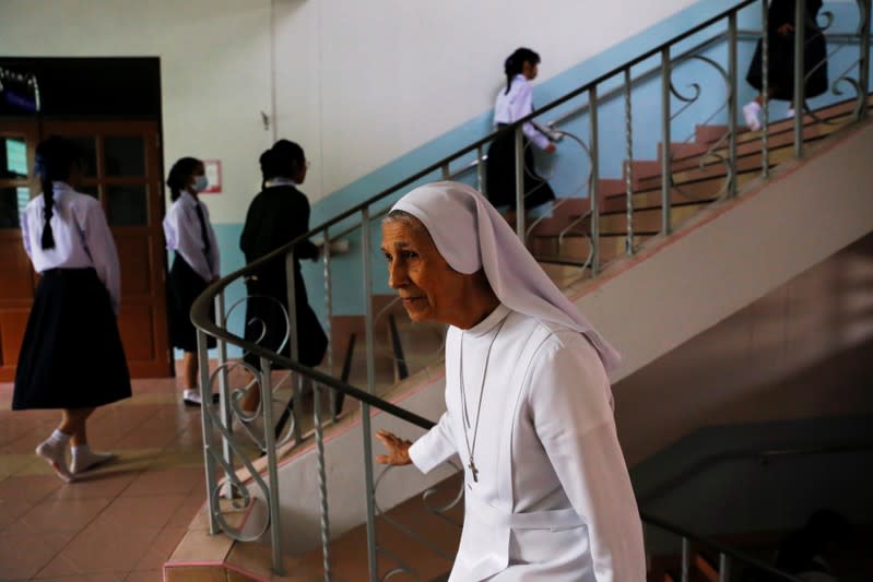 Sister Ana Rosa Sivori walks with students at the St. Mary School in Udon Thani province