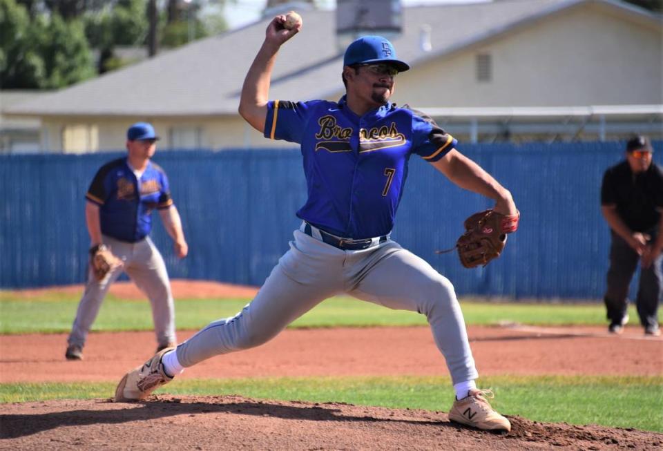 Dos Palos High School senior pitcher Isac Mandujano delivers a pitch during the Central Section Division III semifinal playoff game against Dinuba on Tuesday, May, 23, 2023 at Dos Palos High School.