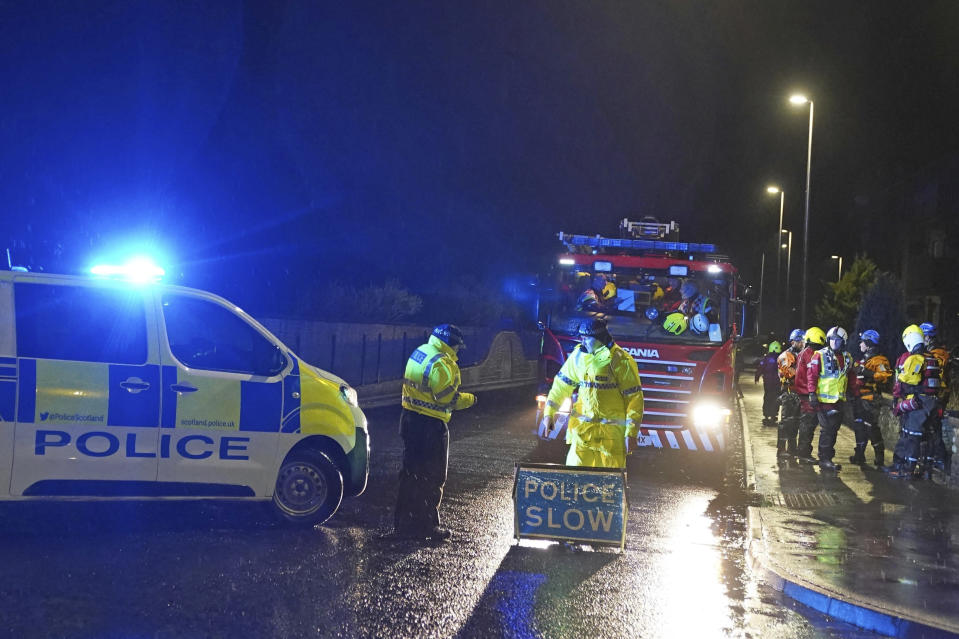 Police close River Street in Stonehaven, Scotland, as members of the fire service ask residents to evacuate due to flood warnings, Thursday, Oct. 19, 2023. Hundreds of people are being evacuated from their homes and schools have closed in parts of Scotland, as much of northern Europe braces for stormy weather, heavy rain and gale-force winds from the east. The U.K.’s weather forecaster, the Met Office, issued a rare red alert, the highest level of weather warning, for parts of Scotland. (Andrew Milligan/PA via AP)