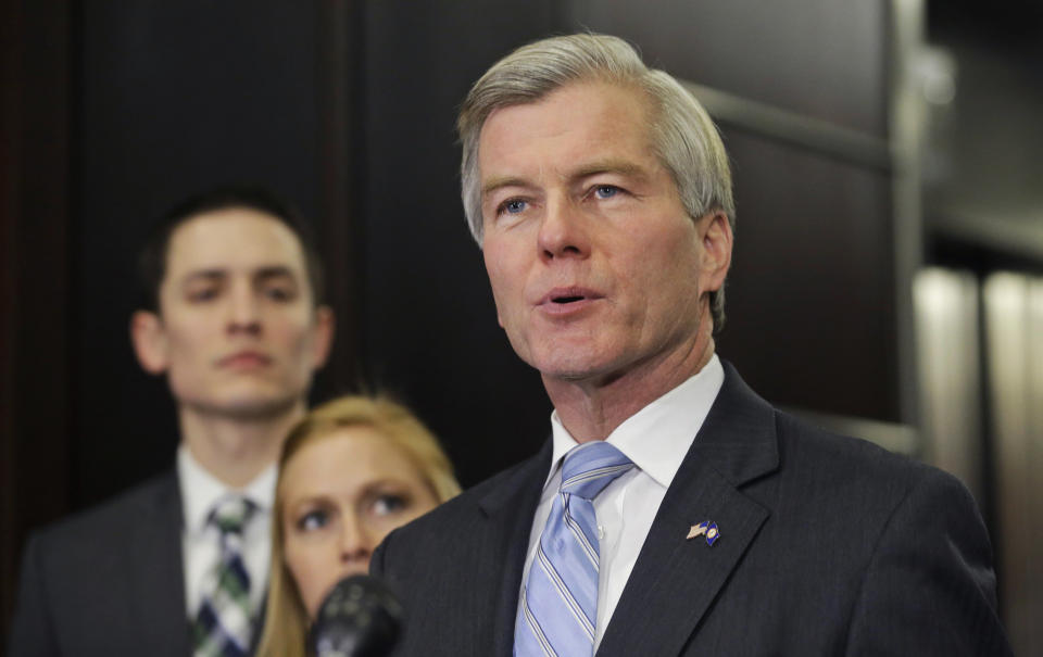 Former Virginia Gov. Bob McDonnell makes a statement as his daughter, Cailin and her husband, Chris Young, listen during a news conference in Richmond, Va., Tuesday, Jan. 21, 2014. McDonnell and his wife were indicted Tuesday on corruption charges after a monthslong federal investigation into gifts the Republican received from a political donor. (AP Photo/Steve Helber)