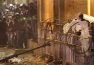 Riot policeman, right, point his rubber bullets gun as he clashes with anti-government protesters, during ongoing protests against the political elites who have ruled the country since decades, in Beirut, Lebanon, Sunday, Jan. 19, 2020. Lebanese security forces used tear gas, water cannons and rubber bullets in clashes with hundreds of anti-government protesters outside the country's Parliament on Sunday, as violence continued to escalate in a week of rioting in the capital.(AP Photo/Hussein Malla)