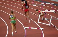 Bulgaria's Vania Stambolova (R) crashes into a hurdle as Lithuania's Egle Staisiunaite (L) and T'Erea Brown of the U.S. run in the women's 400m hurdles round 1 heat during the London 2012 Olympic Games at the Olympic Stadium August 5, 2012. REUTERS/David Gray (BRITAIN - Tags: OLYMPICS SPORT ATHLETICS TPX IMAGES OF THE DAY) 