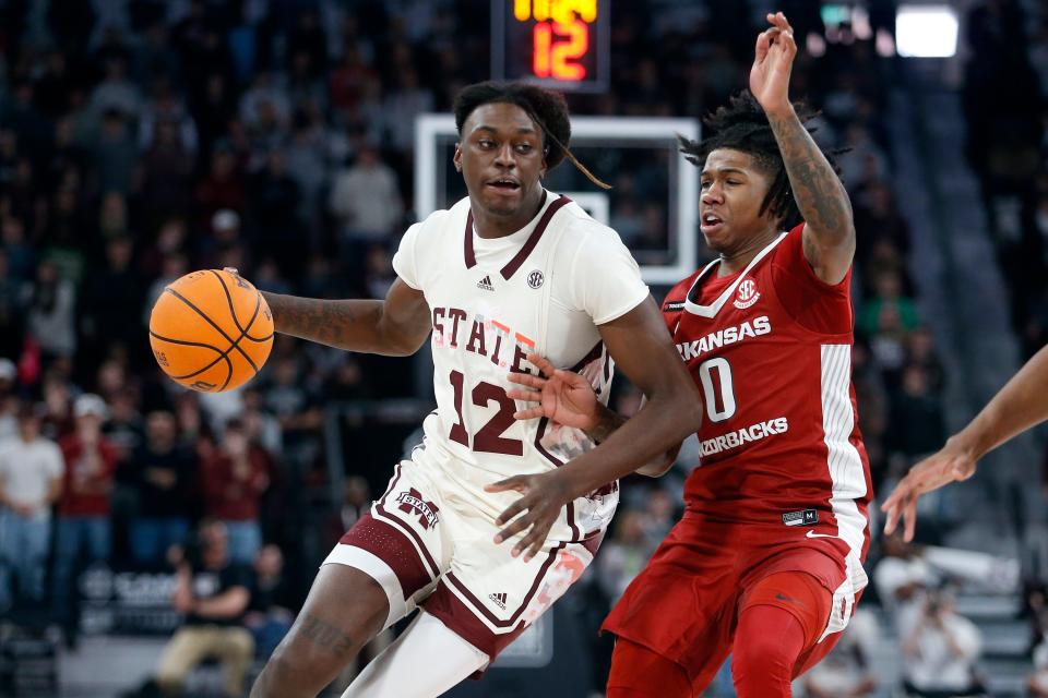 Feb 17, 2024; Starkville, Mississippi, USA; Mississippi State Bulldogs forward KeShawn Murphy (12) drives to the basket against Arkansas Razorbacks guard Khalif Battle (0) during the first half at Humphrey Coliseum. Mandatory Credit: Petre Thomas-USA TODAY Sports