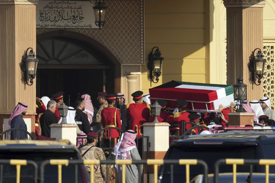 The coffin of the Emir of Kuwait Sheikh Nawaf Al Ahmad Al Sabah is being carried by the guards of honour during his funeral ceremony at the Bilal bin Rabah Mosque in Al-Siddiq district of Kuwait, Sunday, Dec. 17, 2023. Kuwait’s ruling emir, died on Saturday after a three-year, low-key reign focused on trying to resolve the tiny, oil-rich nation's internal political disputes. He was 86. (AP Photo/Jaber Abdulkhaleg)