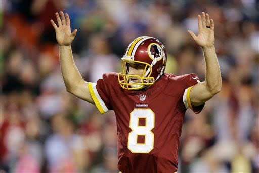 Washington Redskins quarterback Kirk Cousins (8) reacts to wide receiver Andre Roberts' touchdown during the second half of an NFL football game against the Seattle Seahawks in Landover, Md., Monday, Oct. 6, 2014. (AP Photo/Patrick Semansky)