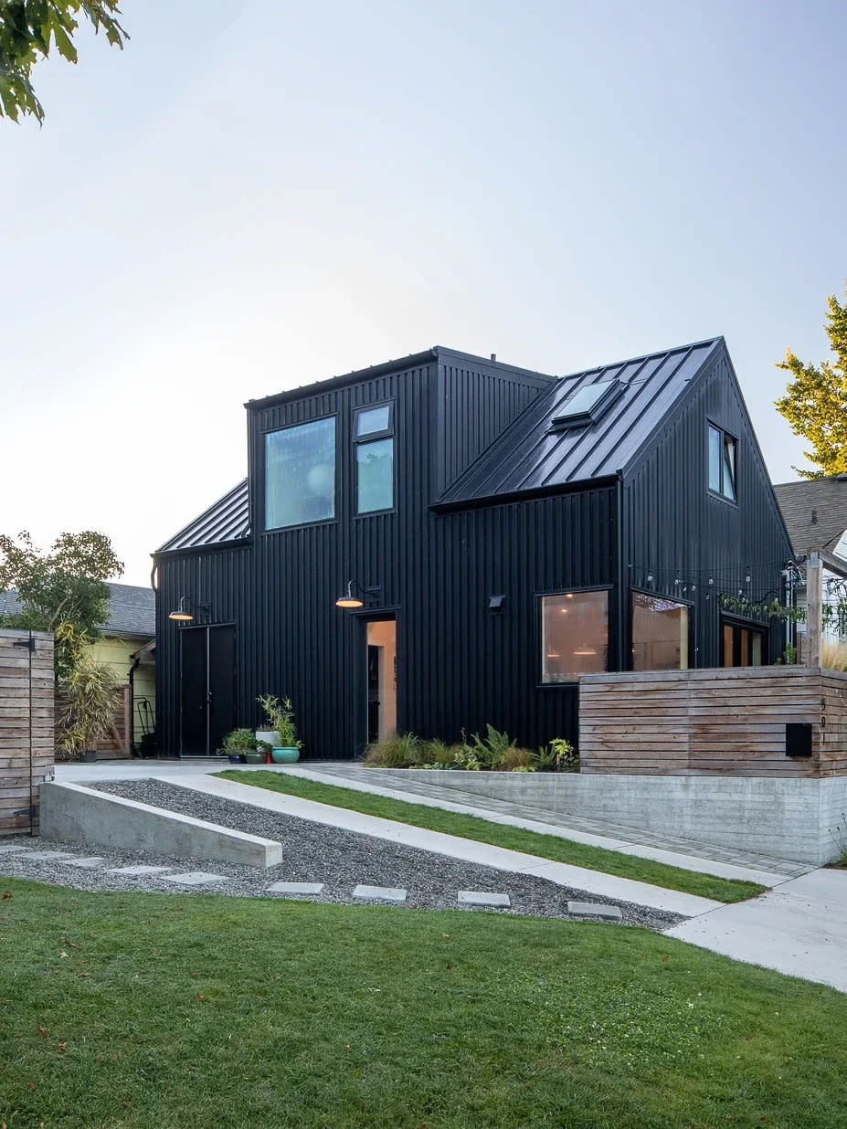 House exterior shown with backyard and covered in black steel.