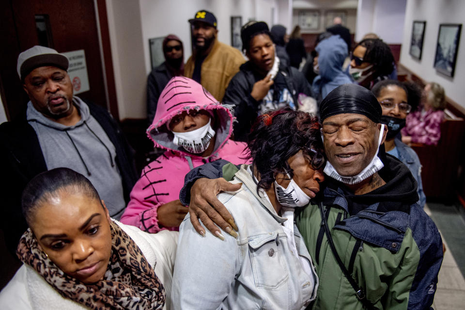 Latryna Sims, partner of Calvin Munerlyn, center, cries on the shoulder of his uncle Ramon Munerlyn, as the family celebrates outside the courtroom after Sharmel Teague, her husband Larry Teague, and son Ramonyea Bishop, three defendants charged in the fatal shooting of the security guard at a Family Dollar store in Flint, Mich., were sentenced to life in prison without the possibility of parole Tuesday, Jan. 17, 2023, in Genesee County Circuit Court. Security guard Calvin Munerlyn refused to allow Teague's daughter inside because she wasn’t wearing a face mask to protect against transmission of the coronavirus. (Jake May/MLive.com/The Flint Journal via AP)