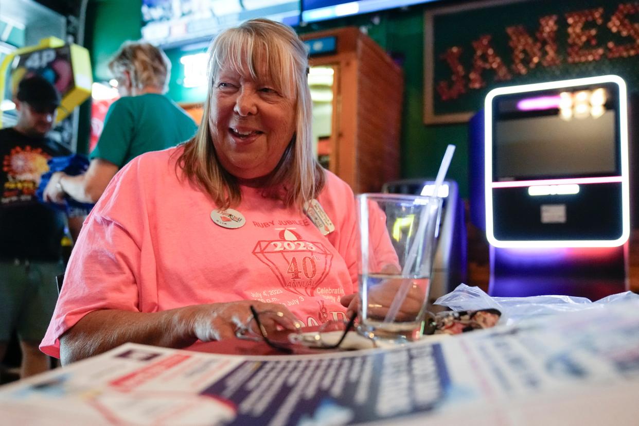 Doo Dah Parade “disOrganizer” and "ChairChick" Deb Roberts oversees the folding and sorting of more than 900 T-shirts at Zeno’s bar in Harrison West. T-shirt sales go toward the operating costs of the parade, which mainly includes hiring police officers for the event. The 40th annual Doo Dah Parade will be held on July 4 in the Short North.