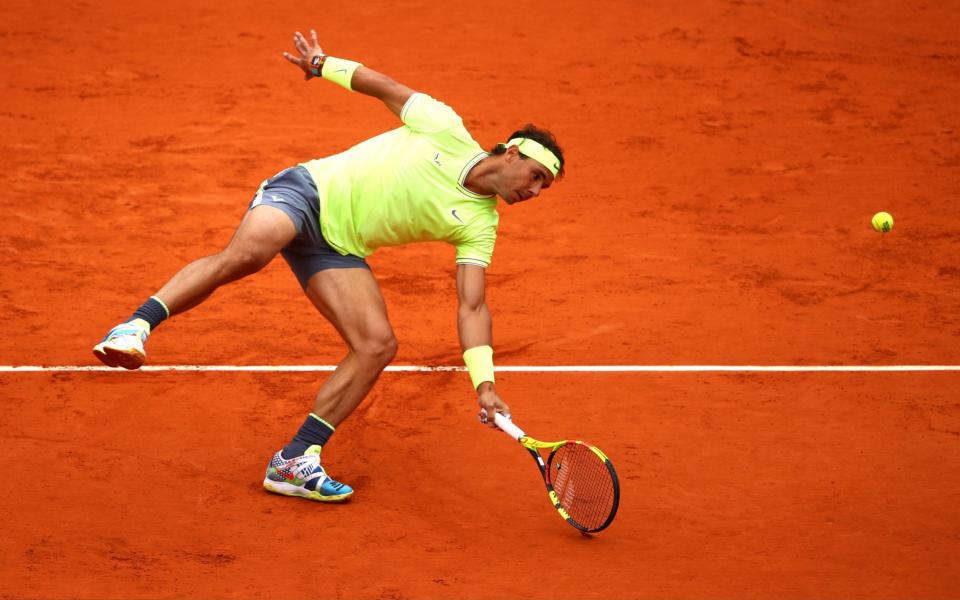 Rafael Nadal of Spain plays a forehand during his mens singles semi-final match against Roger Federer of Switzerland during Day thirteen of the 2019 French Open at Roland Garros on June 07, 2019 - GETTY IMAges