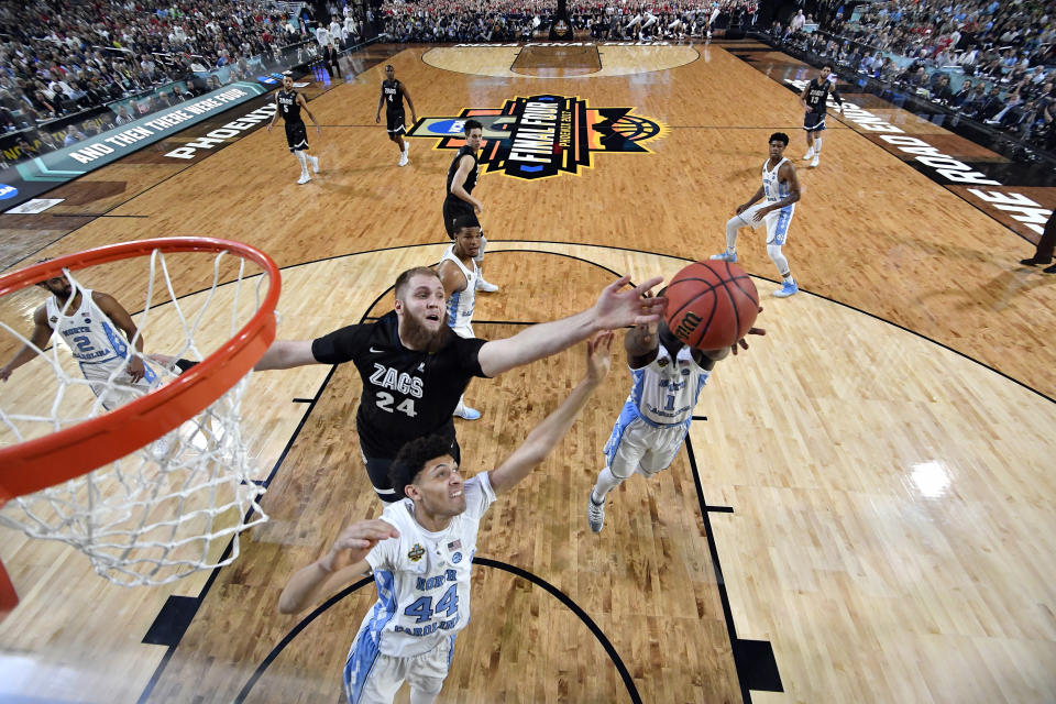 Gonzaga's Przemek Karnowski (24) battles for a rebound against North Carolina's Justin Jackson (44) and Theo Pinson (1) during the first half in the finals of the Final Four NCAA college basketball tournament, Monday, April 3, 2017, in Glendale, Ariz. (AP Photo/Chris Steppig, Pool)