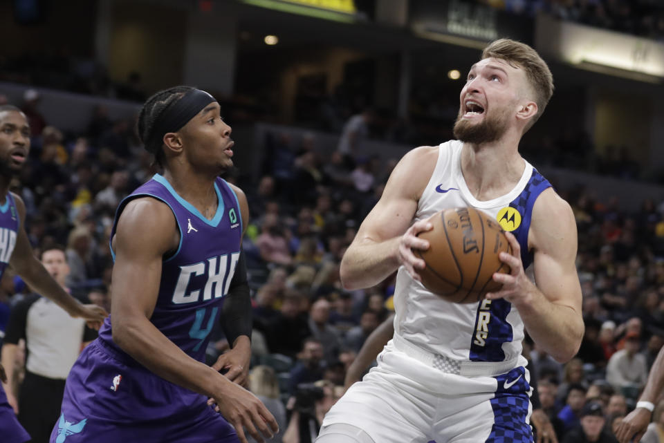 Indiana Pacers' Domantas Sabonis, right, goes to the basket against Charlotte Hornets' Devonte' Graham (4) during the second half of an NBA basketball game, Sunday, Dec. 15, 2019, in Indianapolis. (AP Photo/Darron Cummings)