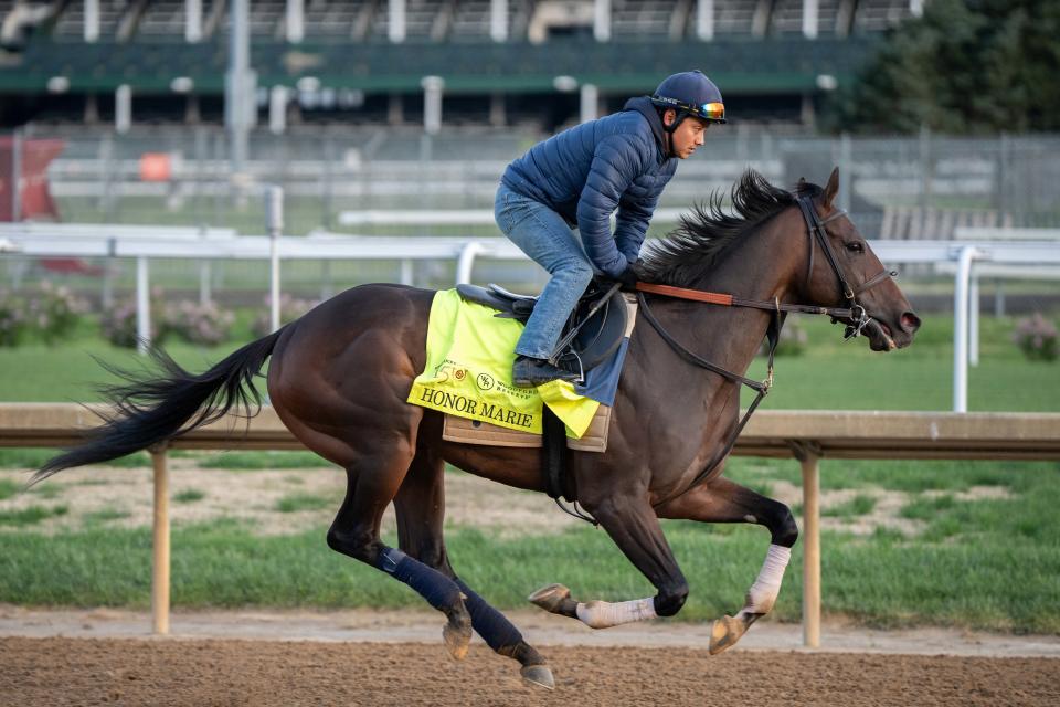 2024 Kentucky Derby contender Honor Marie and assistant exercise rider Morelio Garcia gallop around the track for a morning practice at Churchill Downs on Sunday, April 21, 2024.