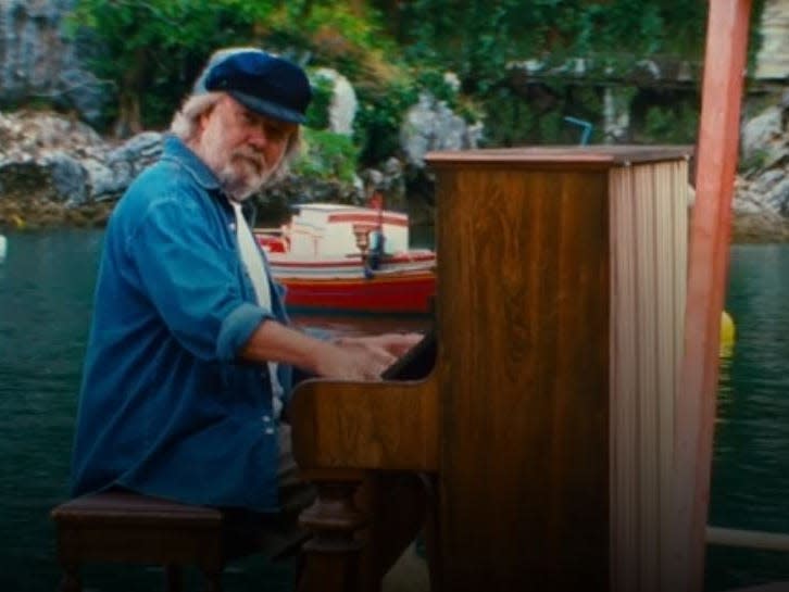 Abba's piano player Benny Andersson playing the piano in mamma mia