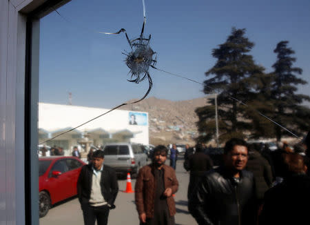 A bullet hole is seen at the entrance gate of a check room in the Intercontinental Hotel after an attack in Kabul, Afghanistan January 23, 2018. REUTERS/Mohammad Ismail