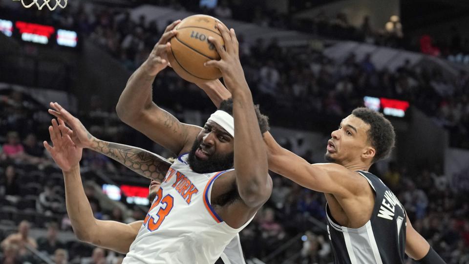 Mar 29, 2024; San Antonio, Texas, USA; New York Knicks center Mitchell Robinson (23) takes rebound away from San Antonio Spurs forward Victor Wembanyama (1) during the first half at Frost Bank Center. Mandatory Credit: Scott Wachter-USA TODAY Sports